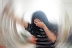 Portrait Of Young Woman Suffering From Vertigo Or Dizziness With Blurred