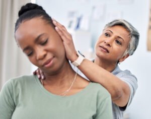 Neck pain, physical therapy and chiropractor with patient, spine injury and healthcare.