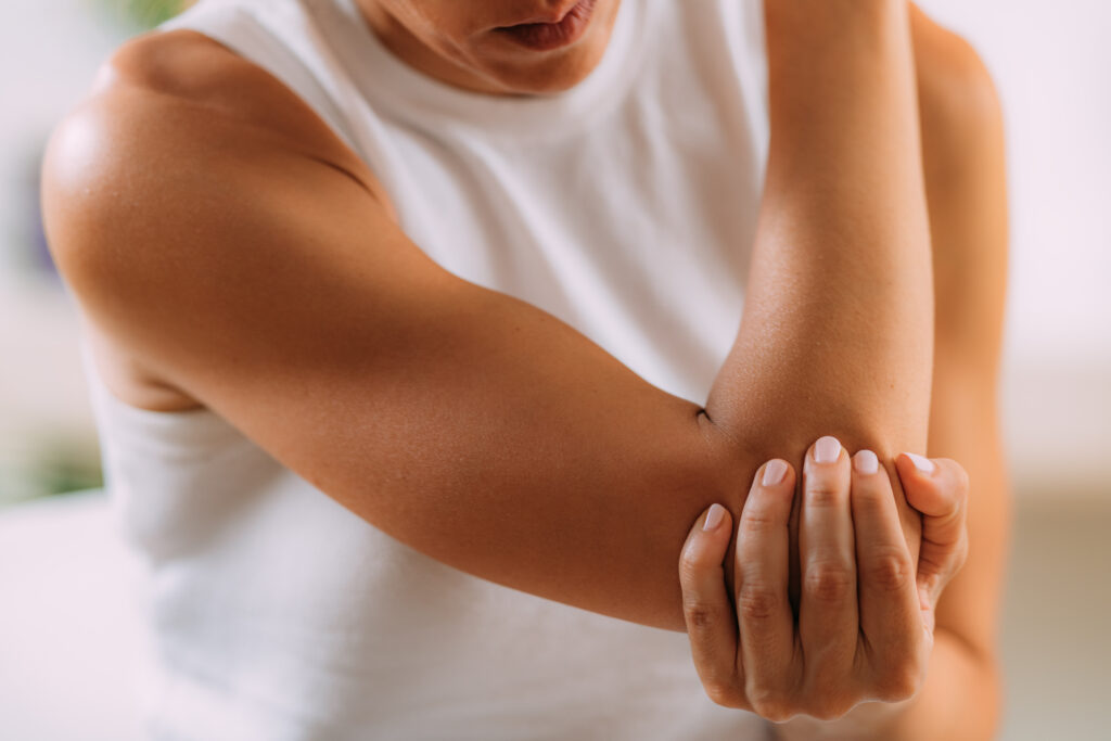 Person holding their elbow in pain