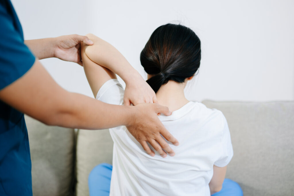 Healthcare professional providing back physiotherapy for pain relief