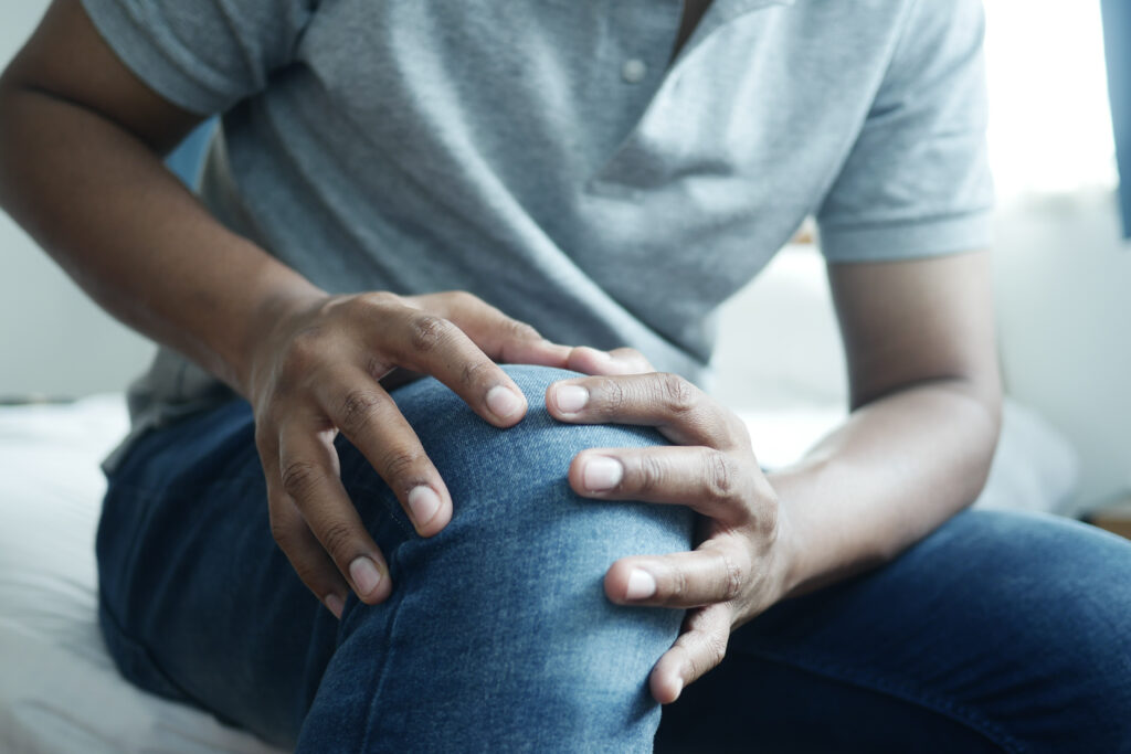 Close up of a man suffering from autoimmune knee joint pain