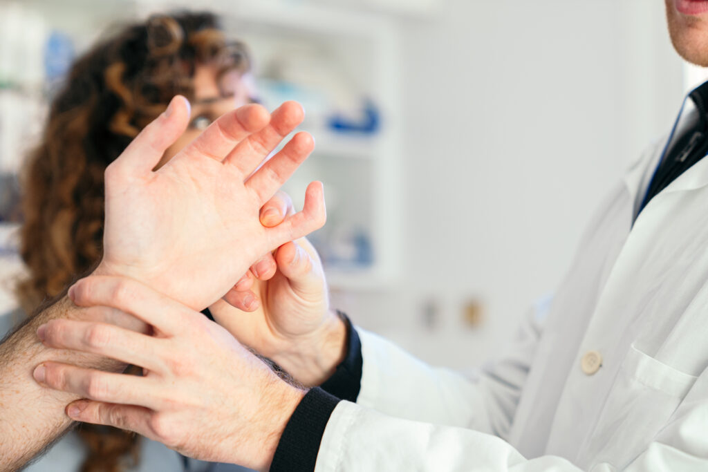Healthcare professionals diagnosing hand trauma in a Tampa FL clinic