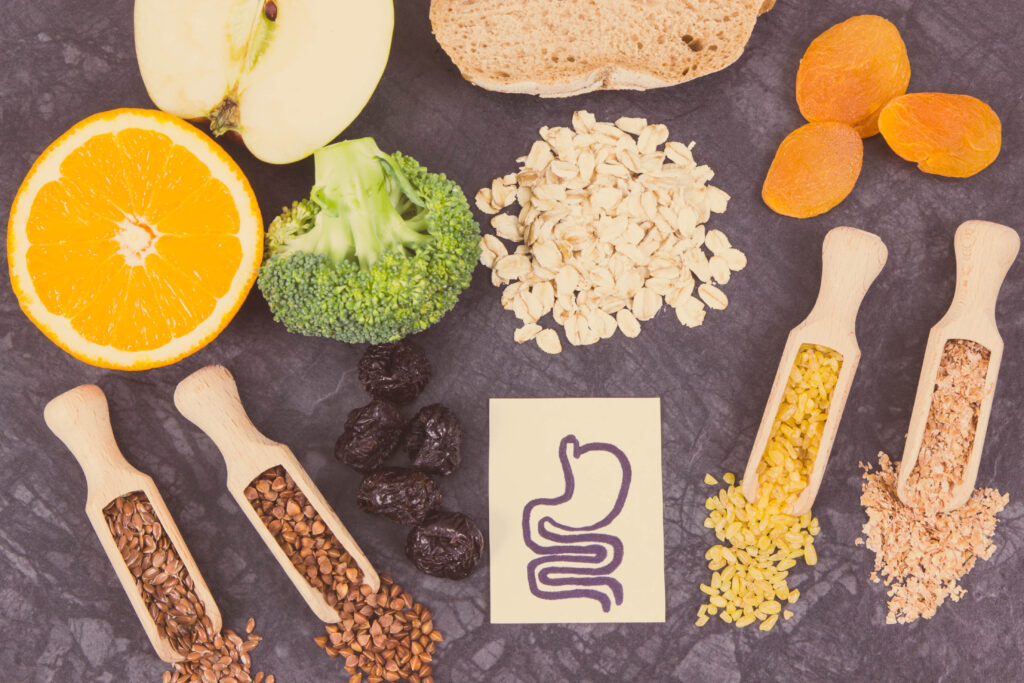 Healthy foods arranged for gut health on a dark surface