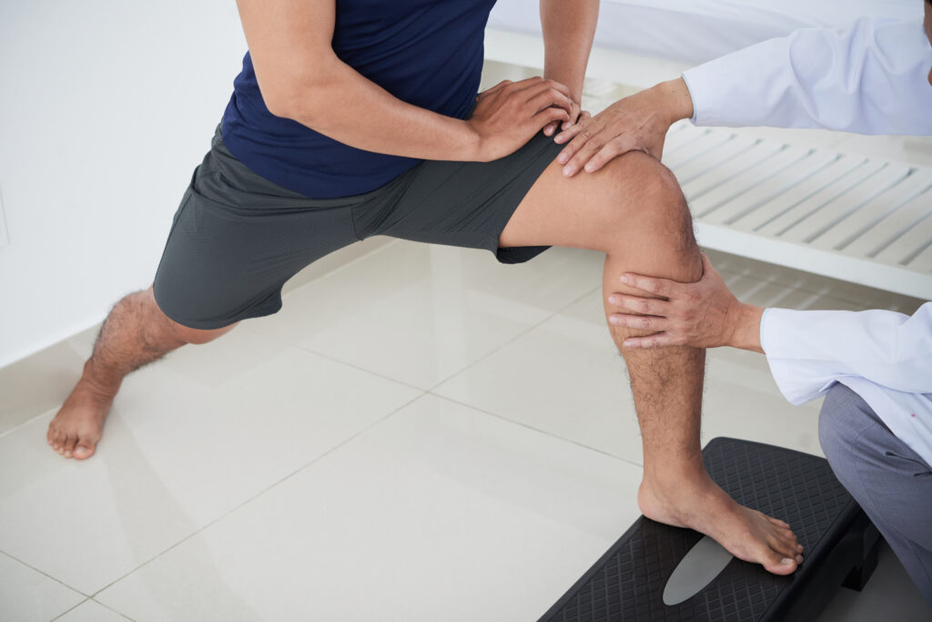Therapist performing knee therapy on a patient in Tampa FL