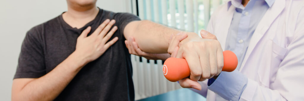 Physiotherapist helping a patient raise her arms for mobility