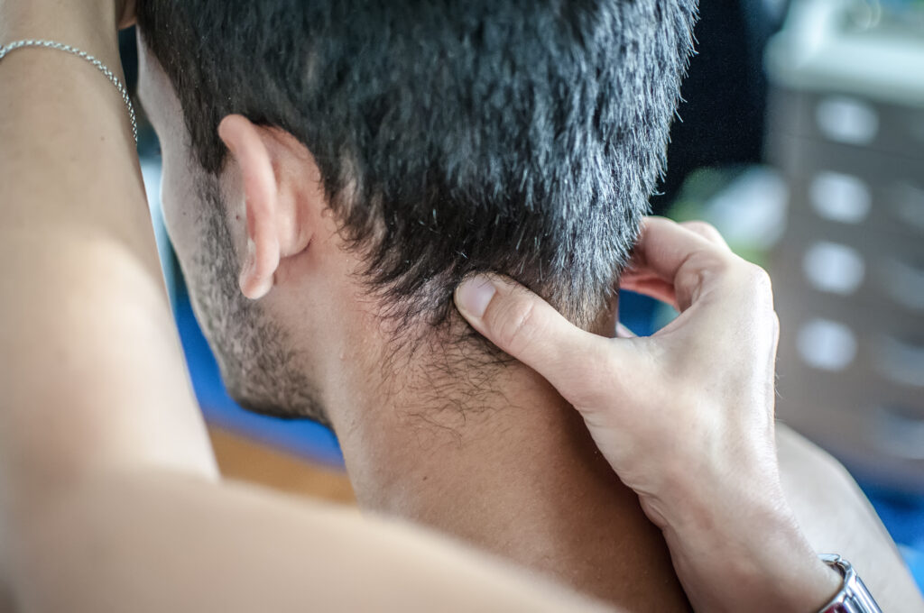 Man receiving massage therapy for neck pain and whiplash treatment