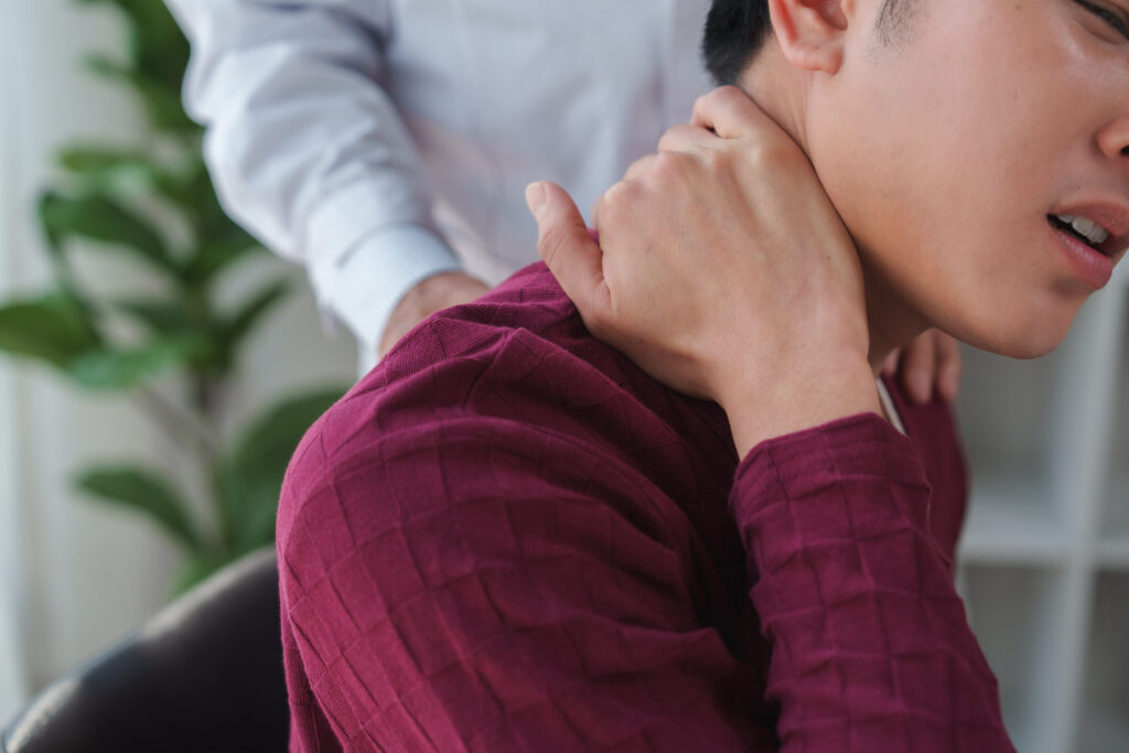 Man receiving neck massage therapy for whiplash relief at Mast Health