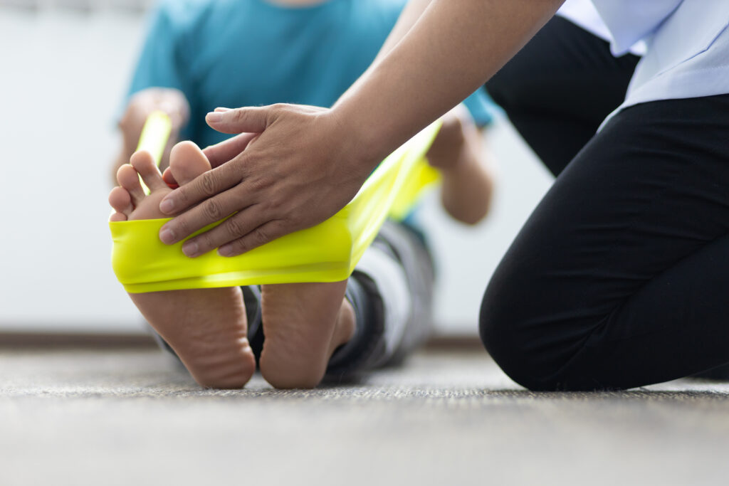Resistance band foot stretch that loosens calf tightness and corrects plantar fasciitis pain, guided rehab available at Mast Health in Tampa, FL
