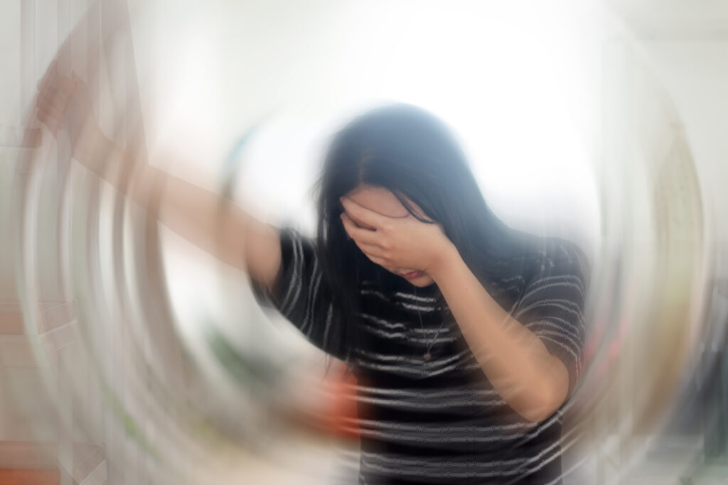 Young woman with blurred motion effect illustrating vertigo and dizziness, a condition supported by Mast Health chiropractic care in Tampa, FL
