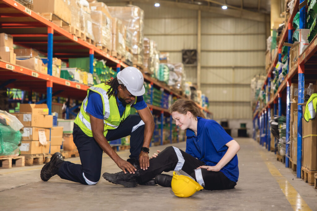 Young warehouse worker with a leg injury from a workplace accident in Tampa